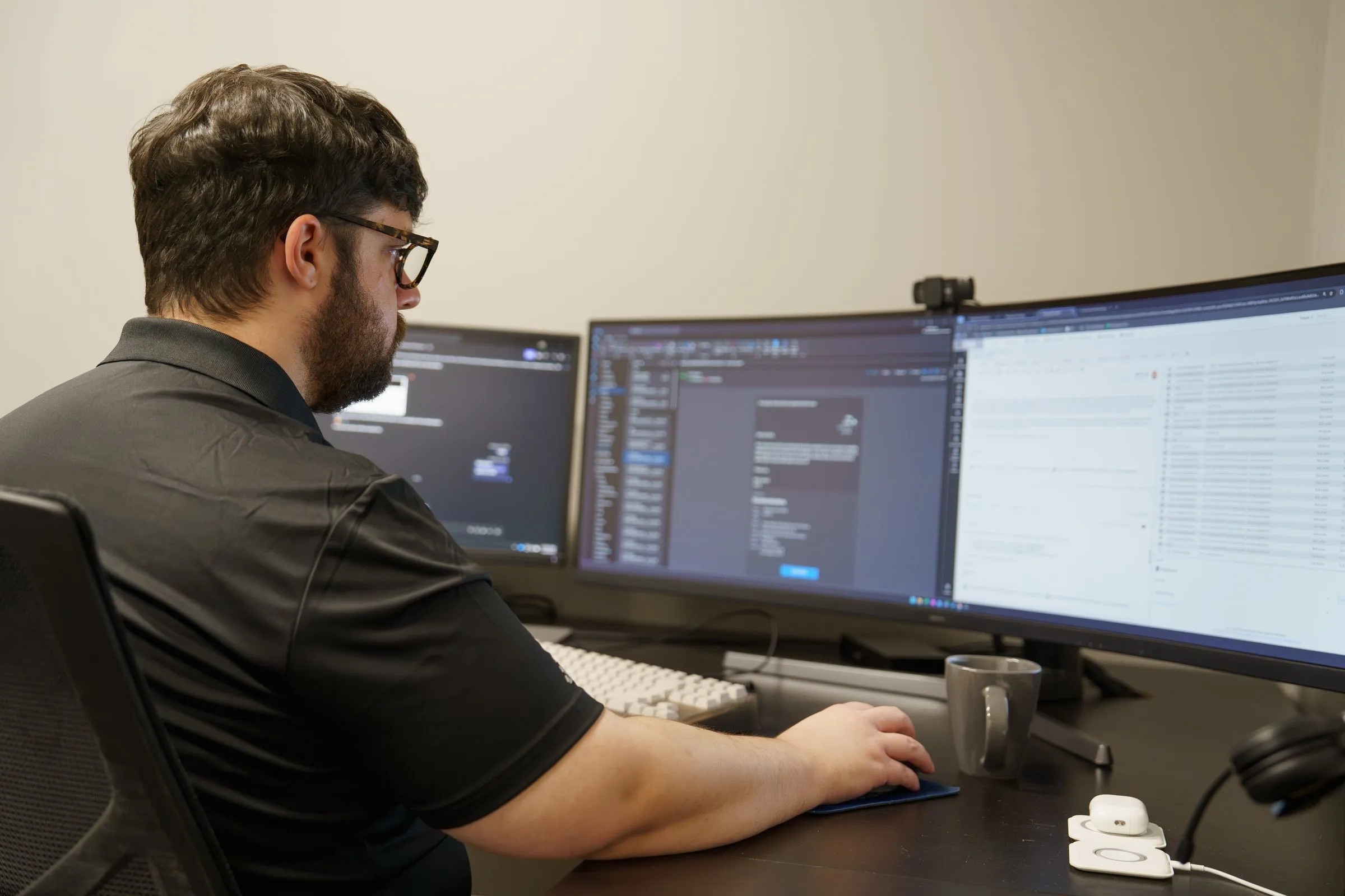 AJTC engineer monitoring client systems across multiple screens
