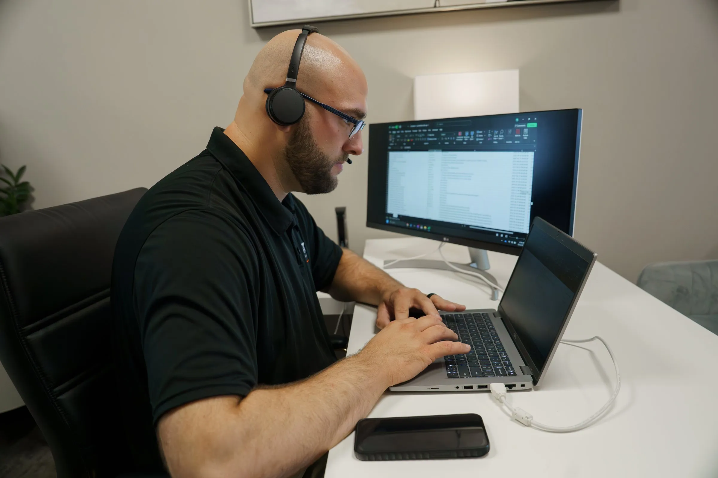 AJTC Phoenix technician answering a call on a headset